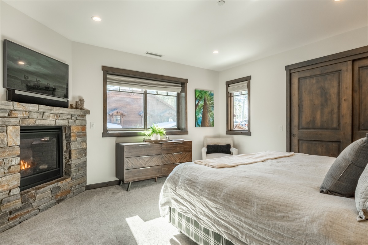 South-facing windows fill the primary bedroom with beautiful natural light, while the fireplace adds warmth and glow—creating a peaceful retreat that feels just right any time of day.