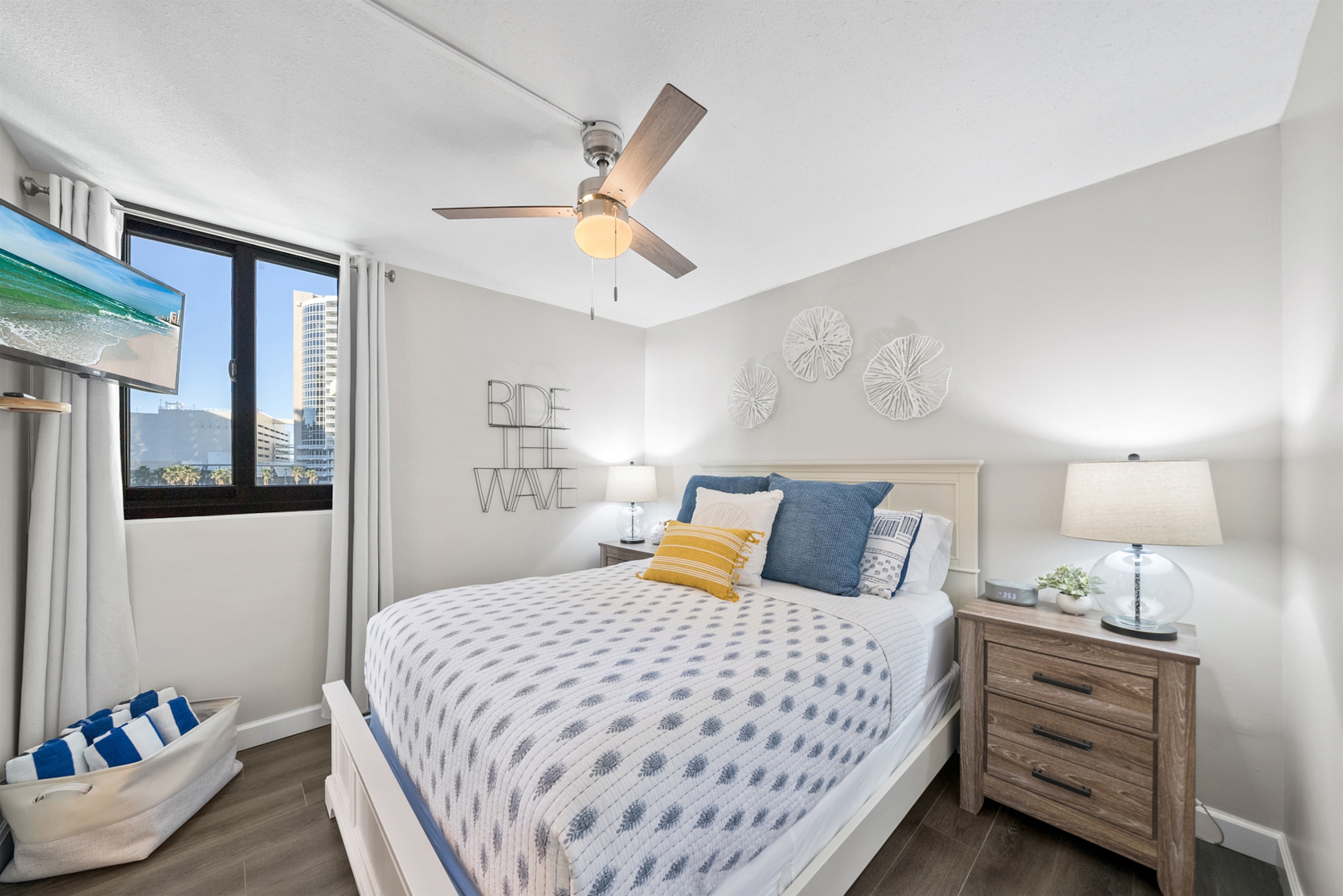 Peaceful queen bedroom with soft linens and a touch of coastal charm.