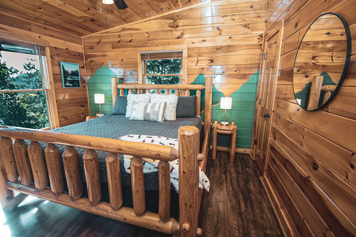 Lounge in the second upstairs king suite in a comfortable, updated log bed, complete with ensuite bathroom.