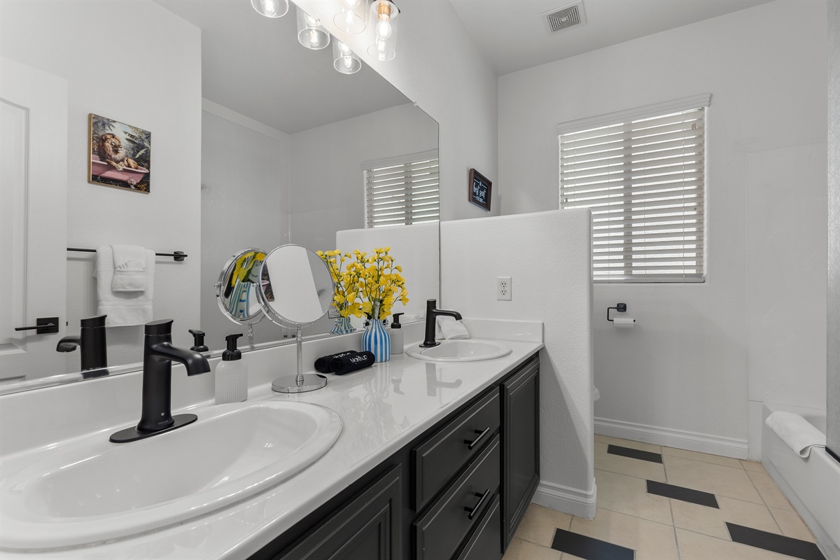 Upstairs hallway bathroom with double sink and a bathtub/shower combo.  The majority of our bathrooms have a double sink. -It's Showtime!