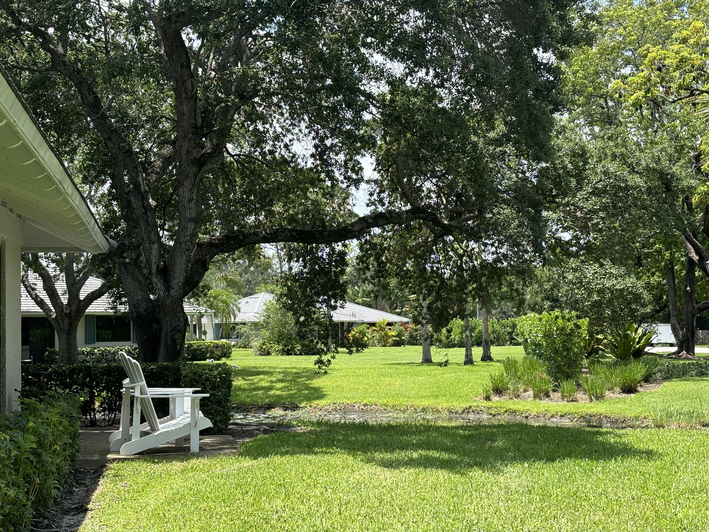 A large tree provides plenty of shade so you can comfortably enjoy sitting outside.