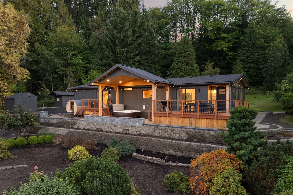 Warm lights shine bright, inviting you inside this cozy evening retreat