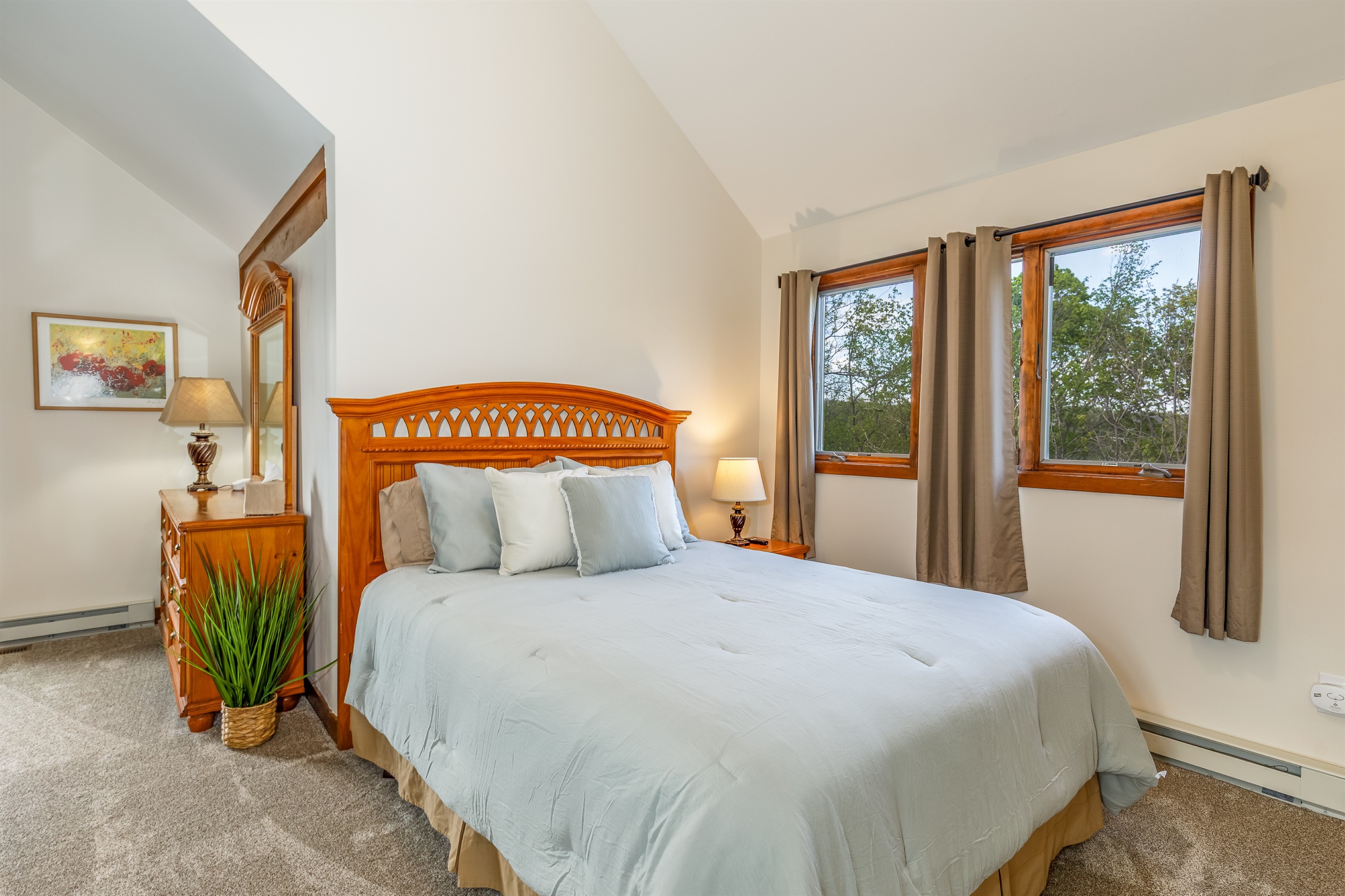 The upper bedroom is spacious with a queen bed and ensuite bathroom.  Note: while this is considered a 3rd bedroom, this space does not have a door. 