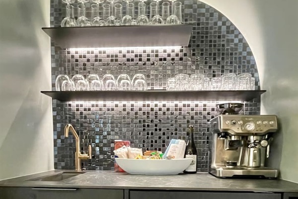Hot & Cold Beverage Station w/ temp controlled wine & cold drink fridge, Expresso maker, French Press, Drip Coffee Maker, Nespresso, Electric Kettle, bar sink, pantry and really cool LED accented shelving to set just the right vibe