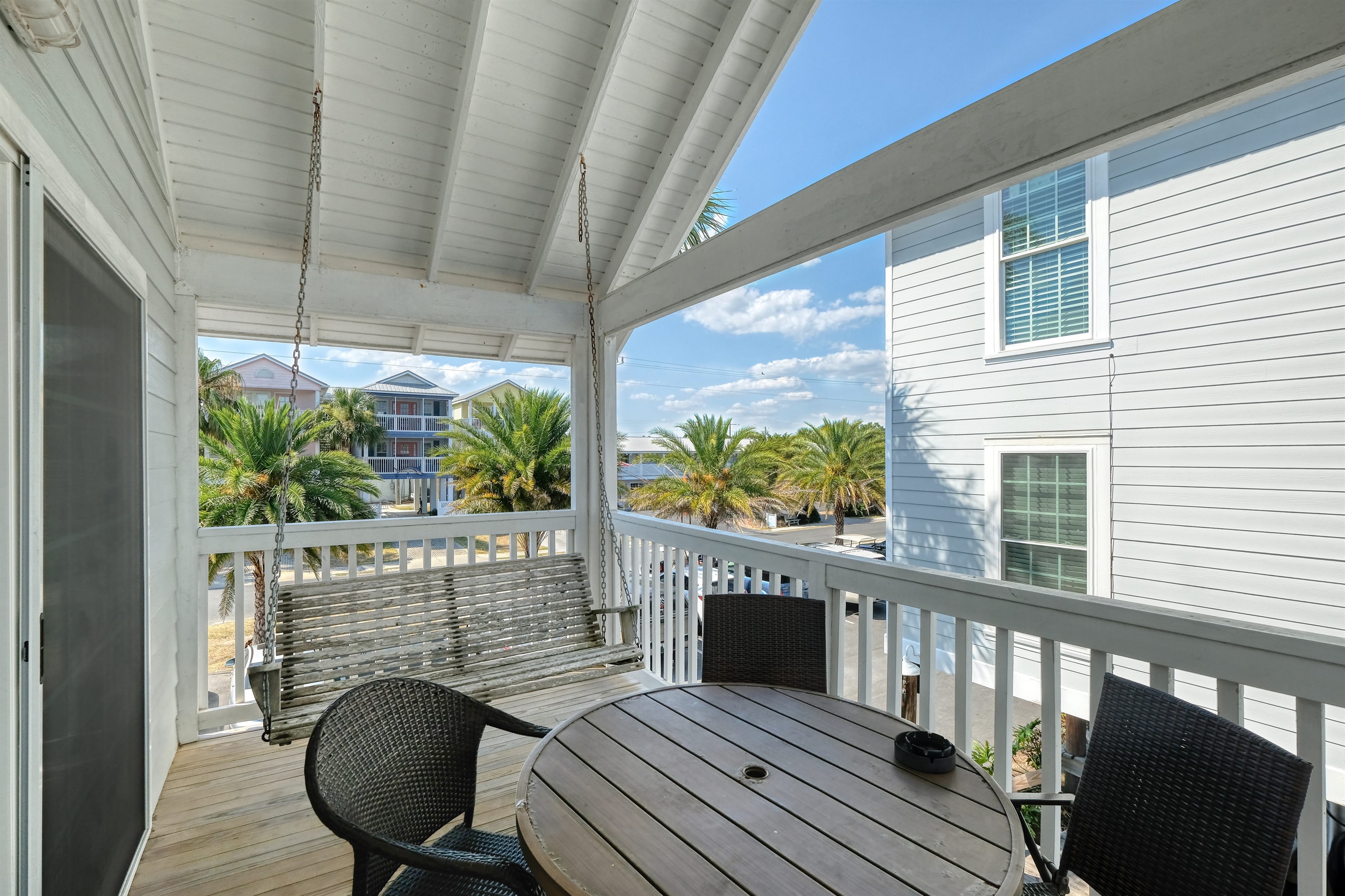 Porch has table and chairs for out door eating