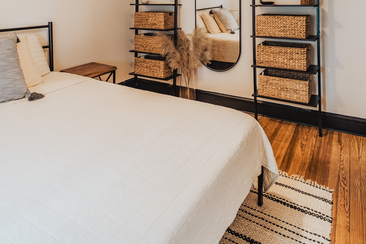 Side Angle View of Bedroom 1 Displaying Bed Setup with Woven Baskets,