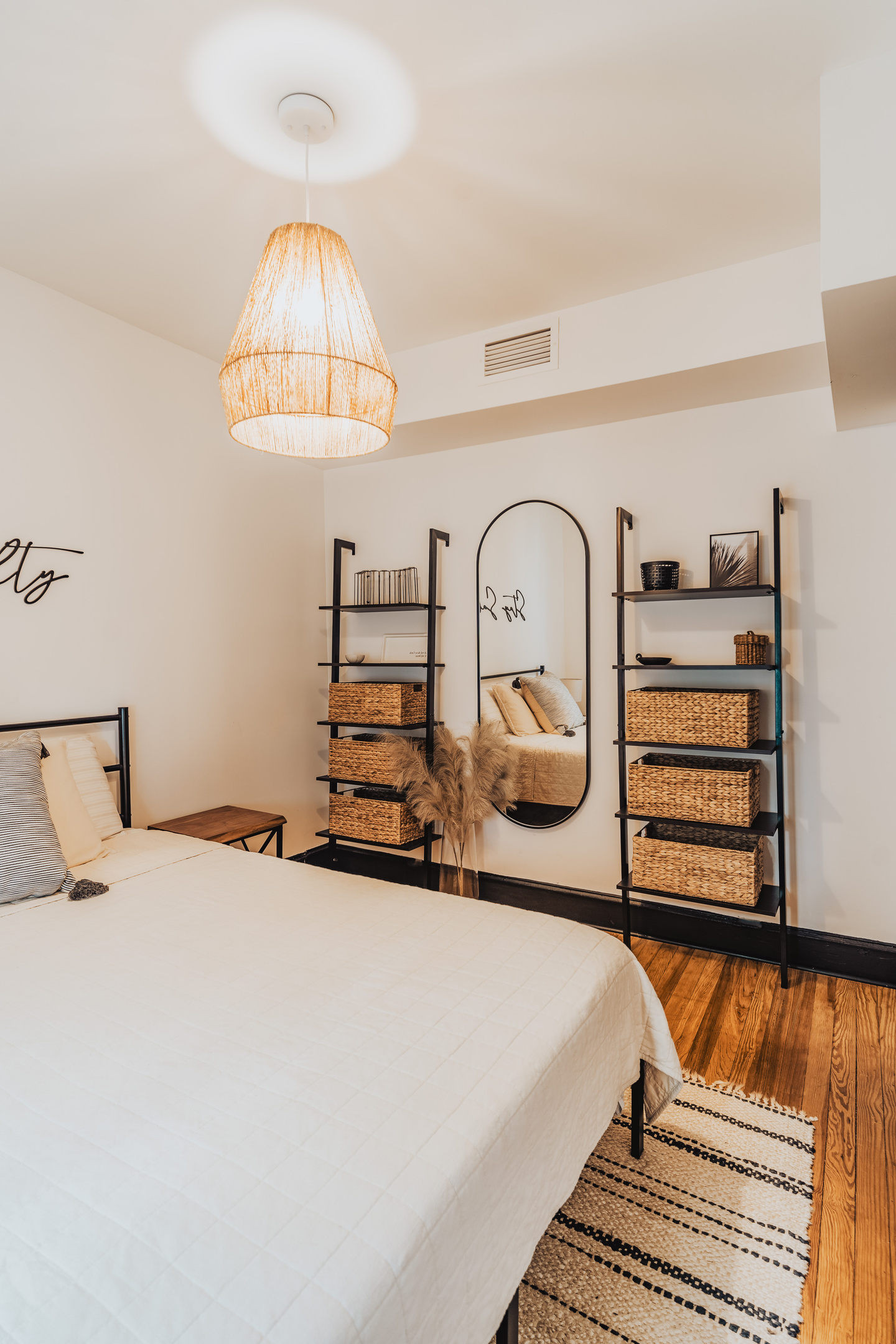 Side Angle View of Bedroom 1 Displaying Bed Setup with Woven Baskets,