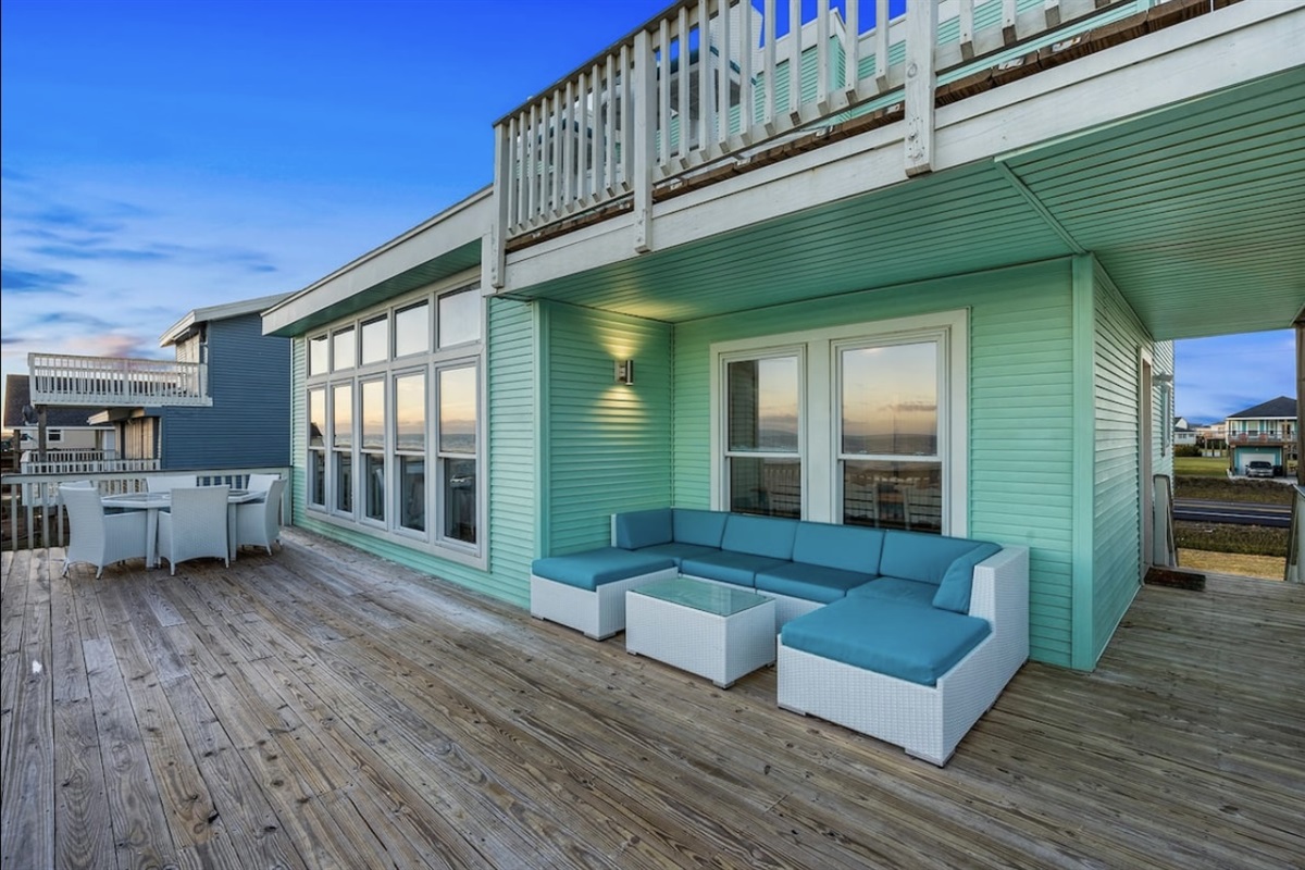 Extending off the living area, the second-floor balcony is the perfect place to enjoy morning coffee or an evening glass of wine as it overlooks a pristine stretch of beach.