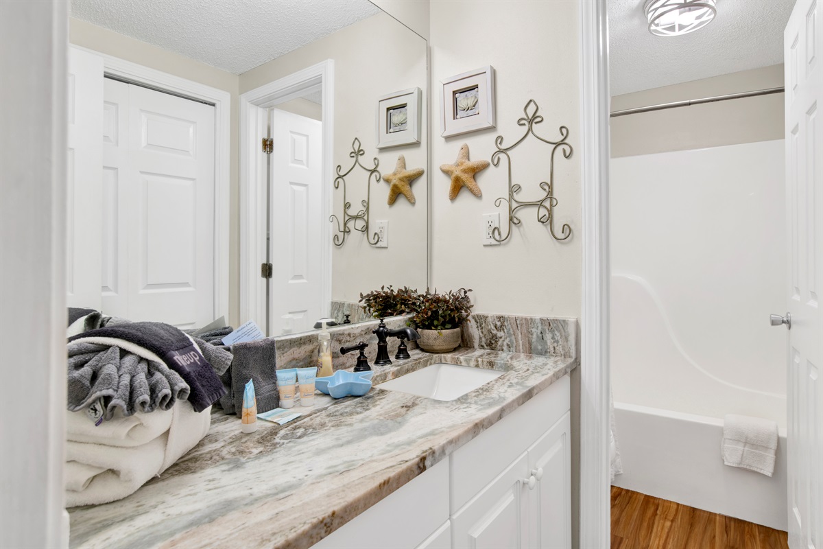 En-suite bathroom with granite tops and a water closet with tub/shower combo 