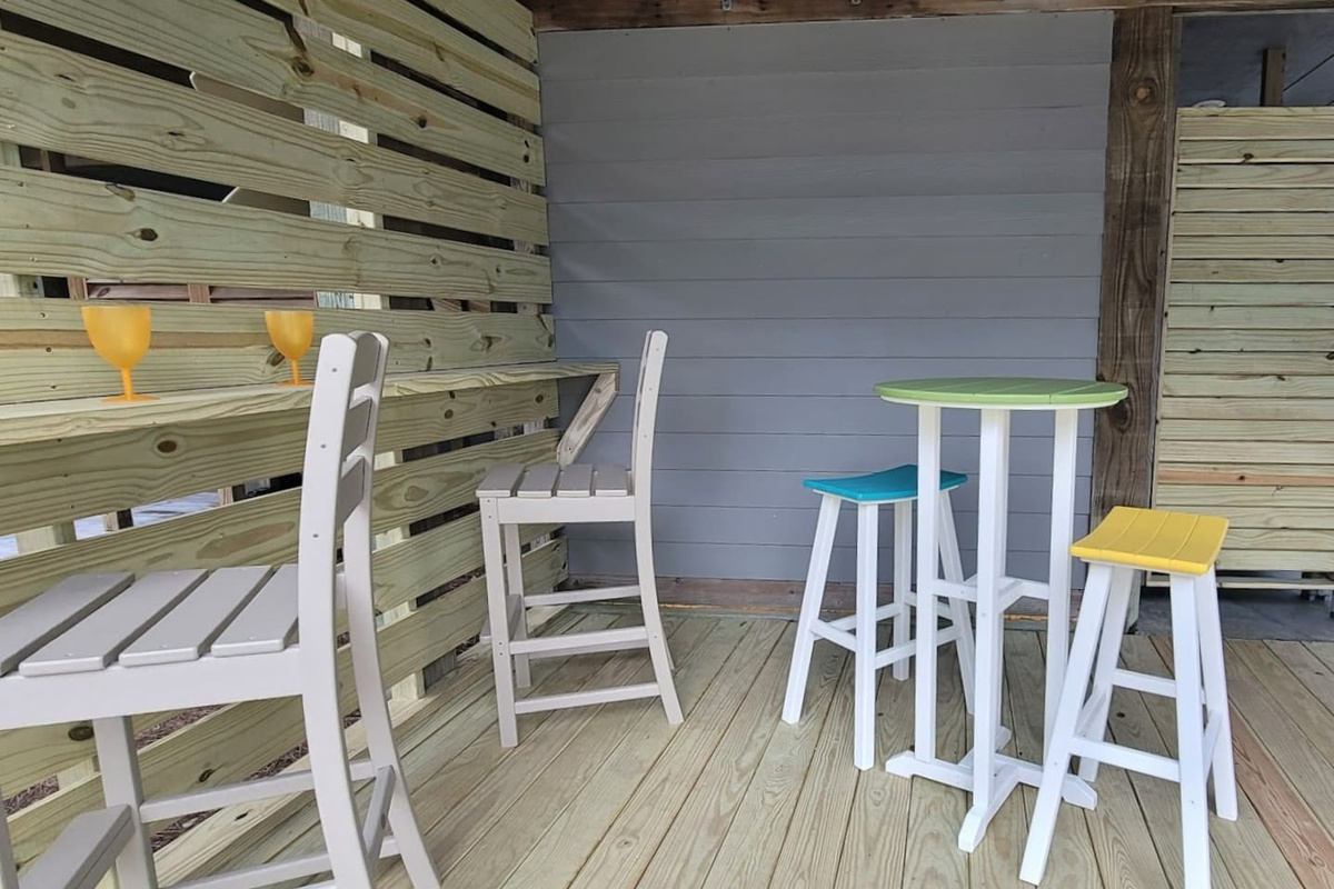  Spread out at the lower-level outdoor dining table &mdash; extra space when everyone wants to eat outside at once.