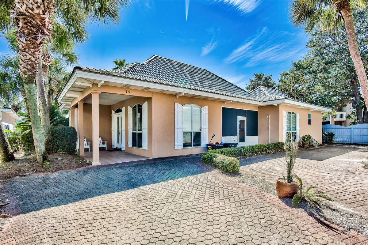 Real Sandy exterior with private driveway and beautifully maintained coastal landscaping