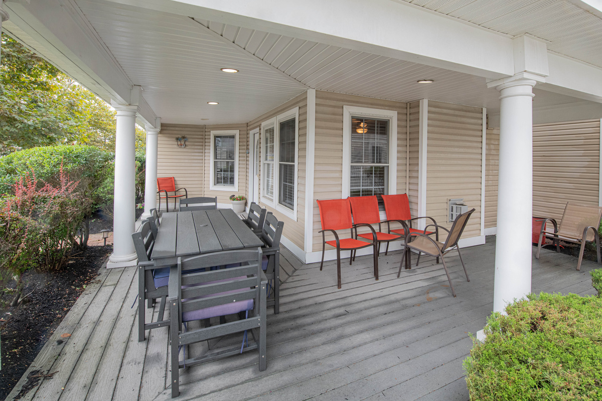 Front Porch with Outdoor Dining Table and Seating Area
