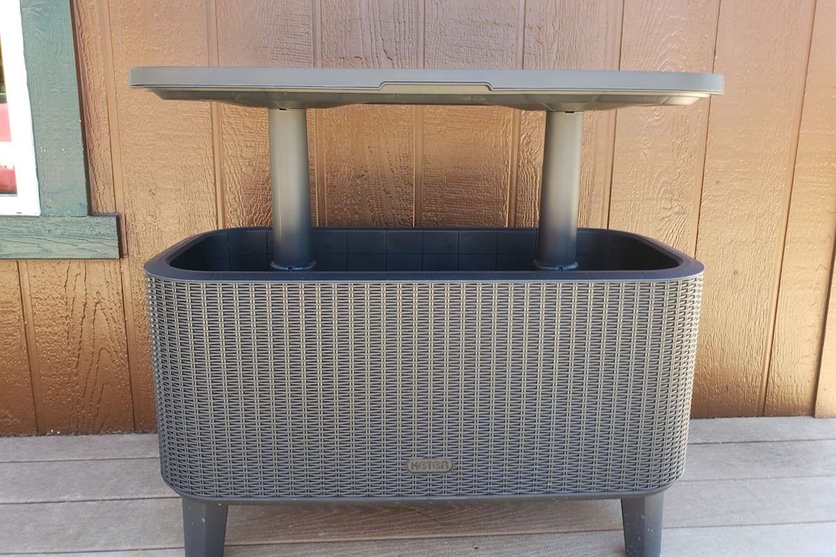 Deck drink cooler with table that raises