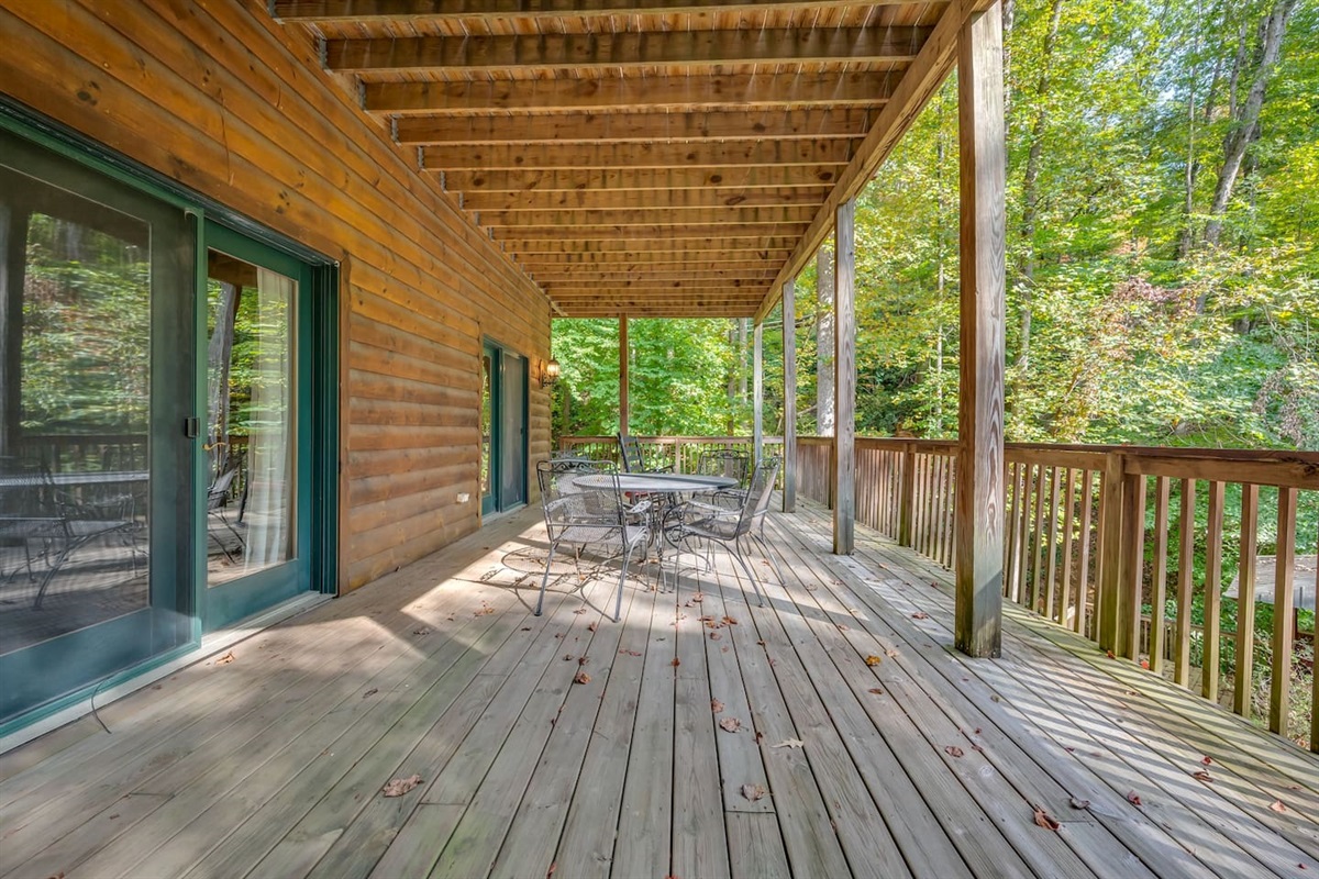 Lower level deck with steps to back yard. French Doors from Master bedroom 3 and 4th bedroom/gameroom access lower deck. Lower deck has chairs /table and rocking chairs