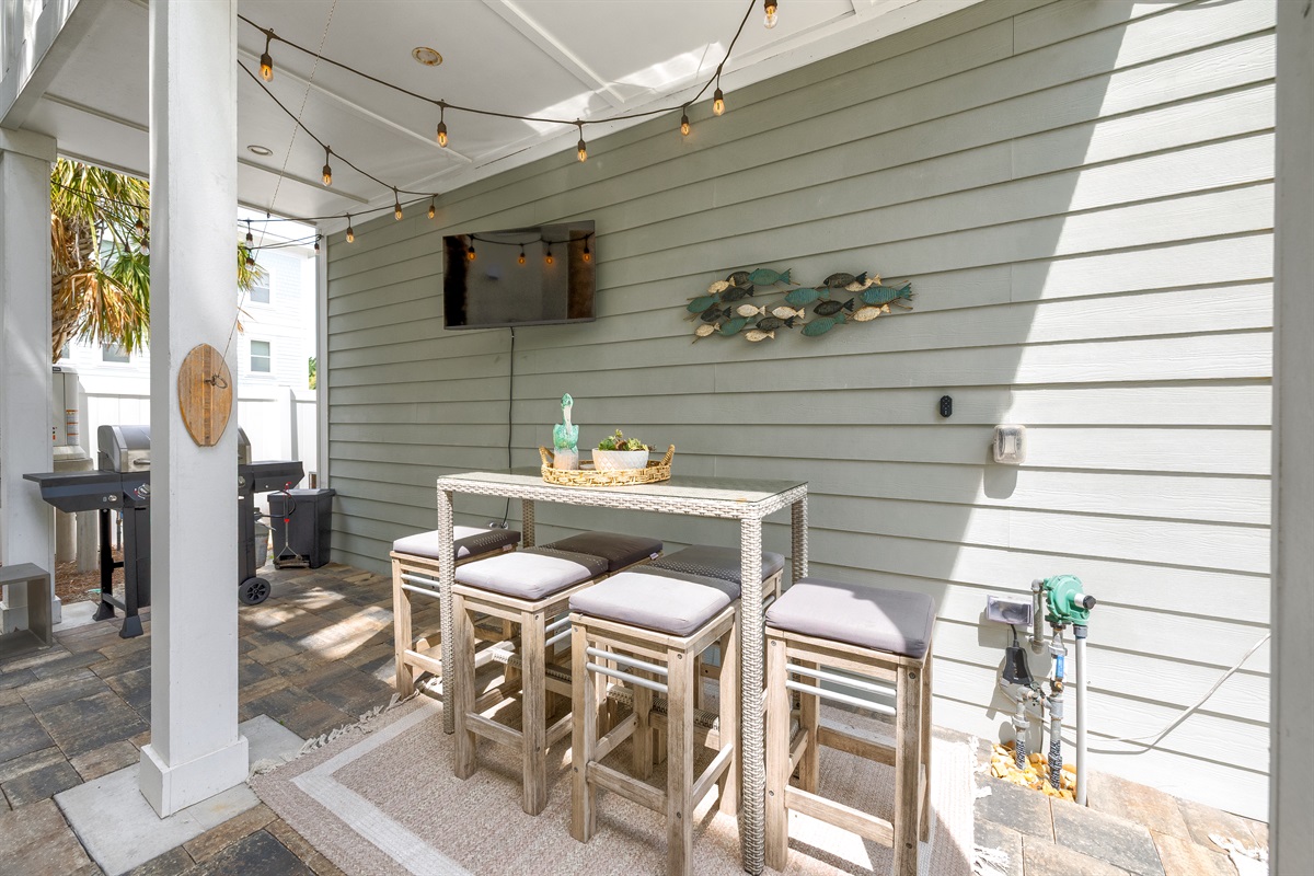 Covered bar seating & TV for game day gatherings