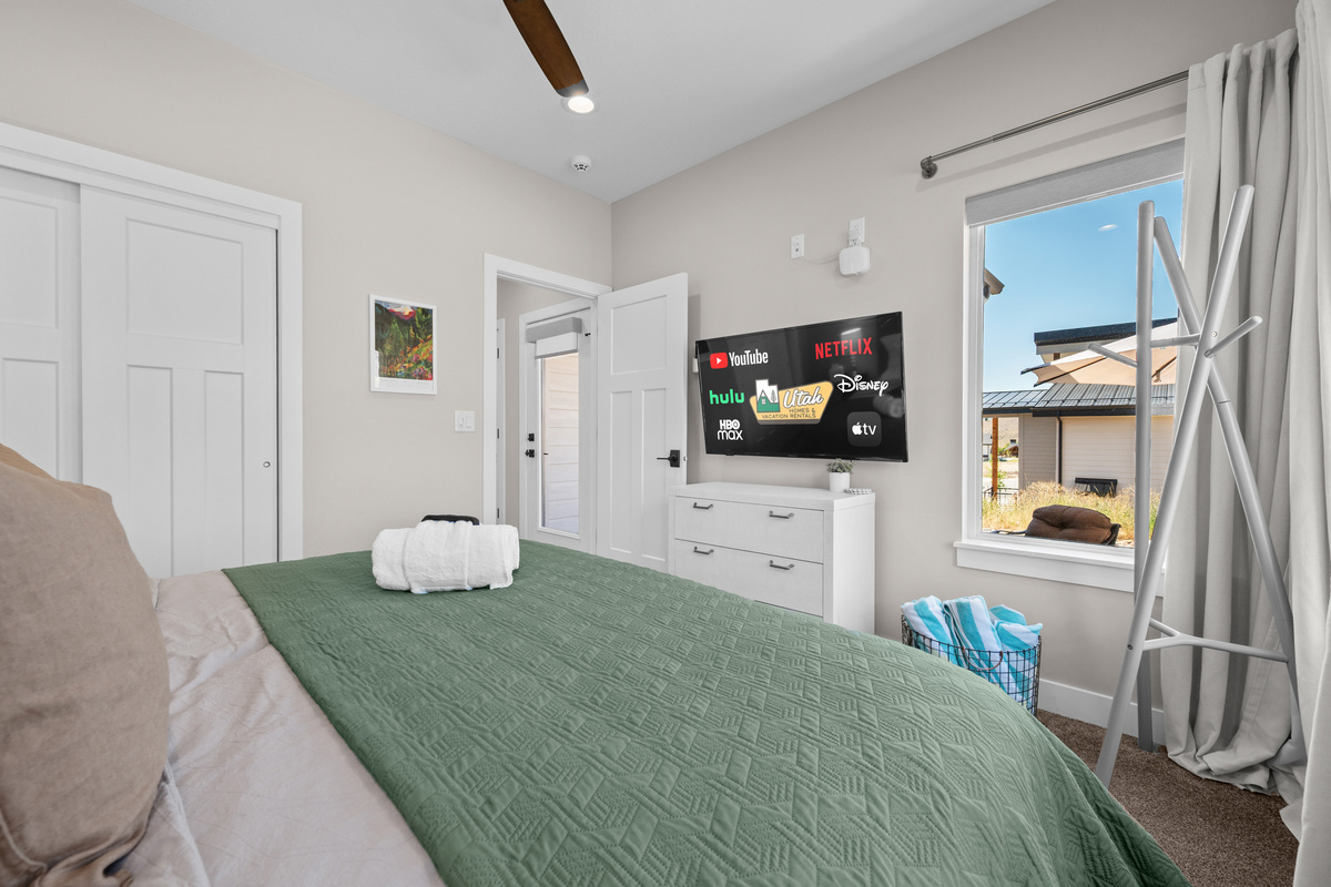 Comfortable king bedroom with a Smart TV, mountain-inspired décor, and plenty of space to unwind during your mountain getaway.
