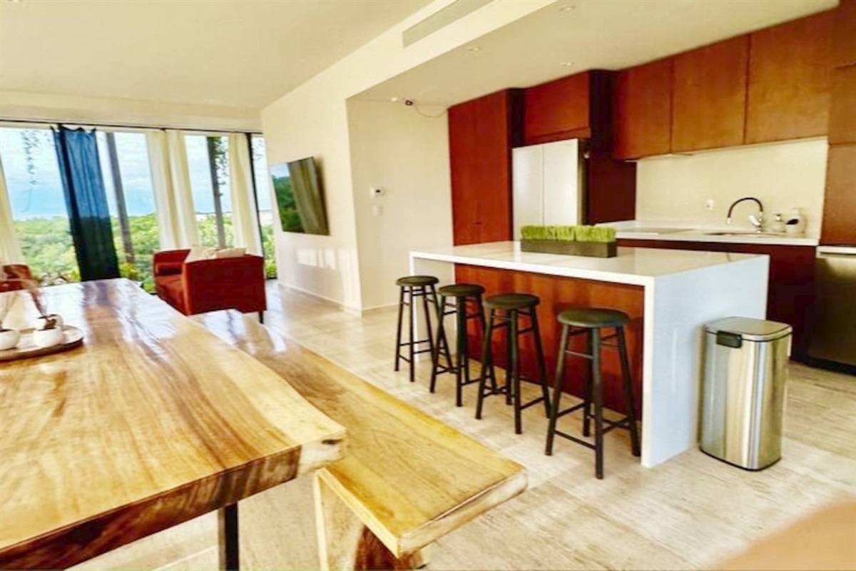 Dinning area has a large 3 meter table with two benches. Perfect for meals, working and hanging out.