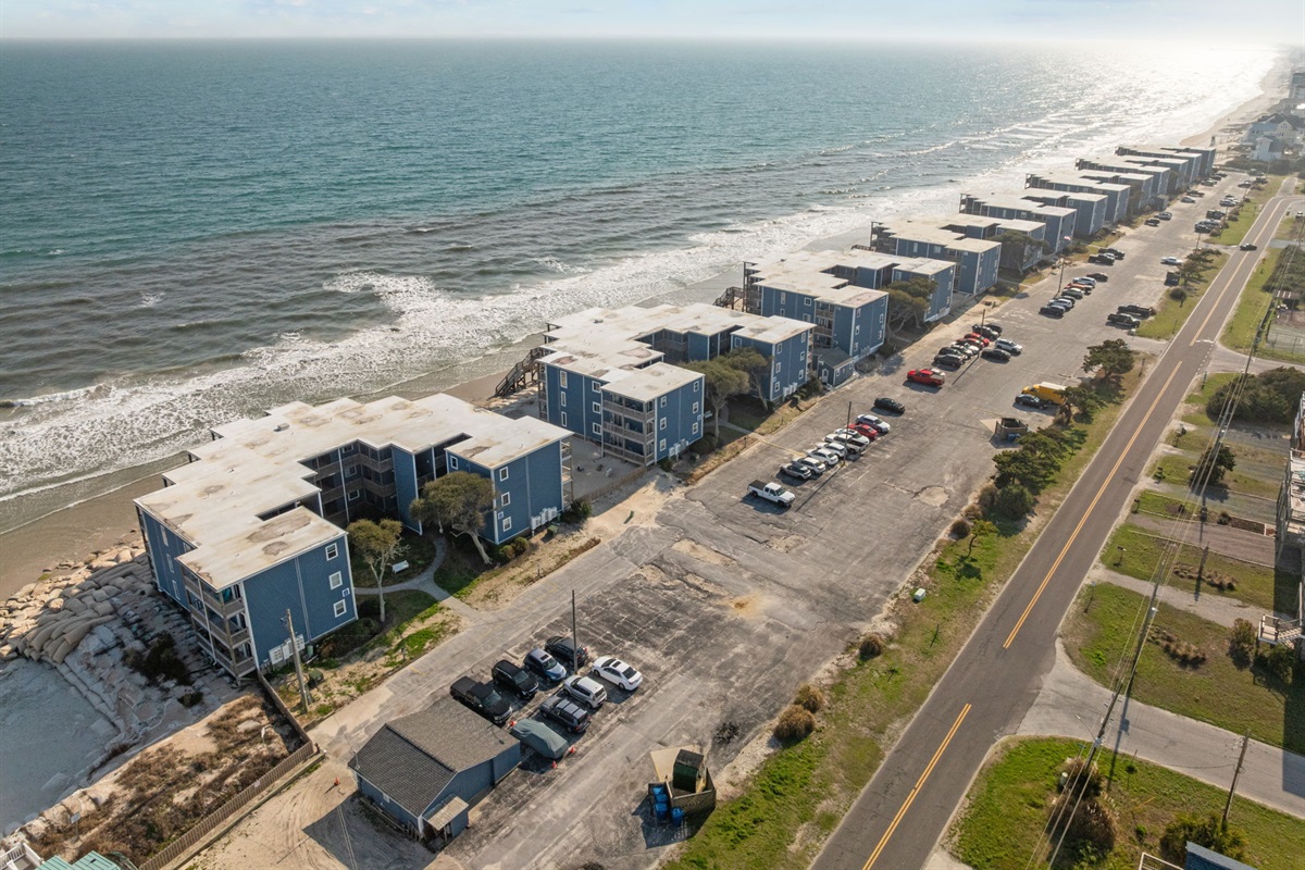 Bird&rsquo;s-eye view highlighting the parking area off New River Inlet Road and the oceanfront location