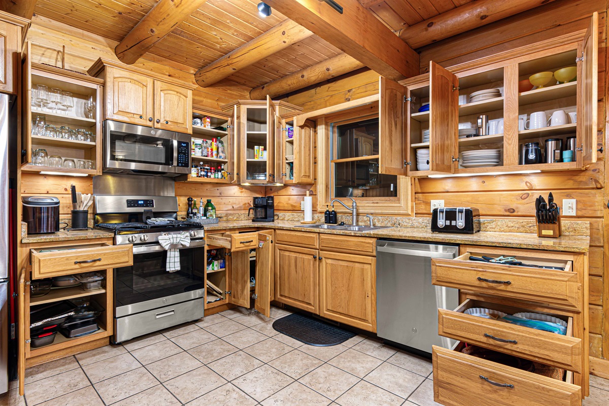Main Level Kitchen: Whip up culinary masterpieces with modern appliances & rich wooden accents!