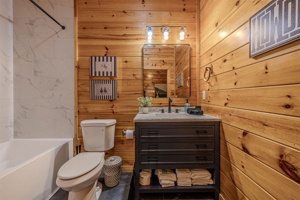 The connected bunk room has a full bath with a large tub