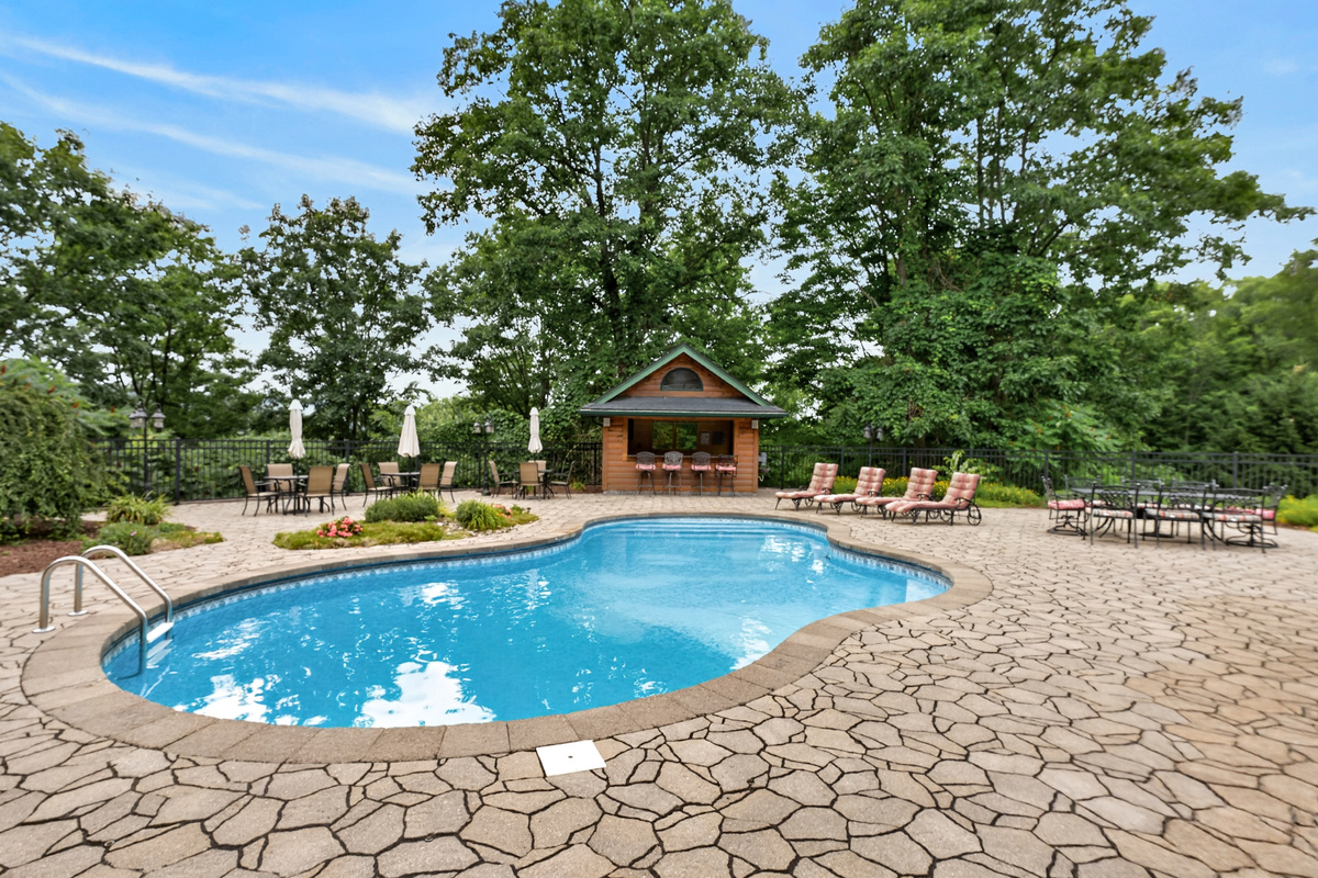 Swimming pool with lounge chairs and tiki bar 