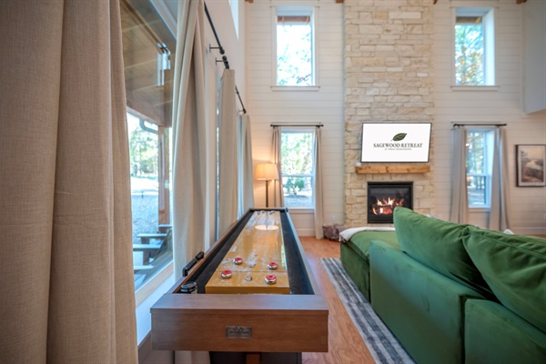 The best kind of game night: crackling fireplace, soft lighting, and shuffleboard ready to play. 🔥🤎