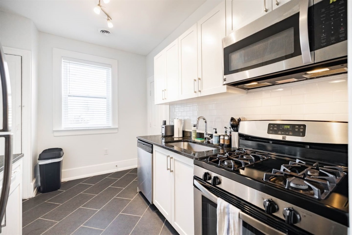 Kitchen with complete set of cooking equipment.