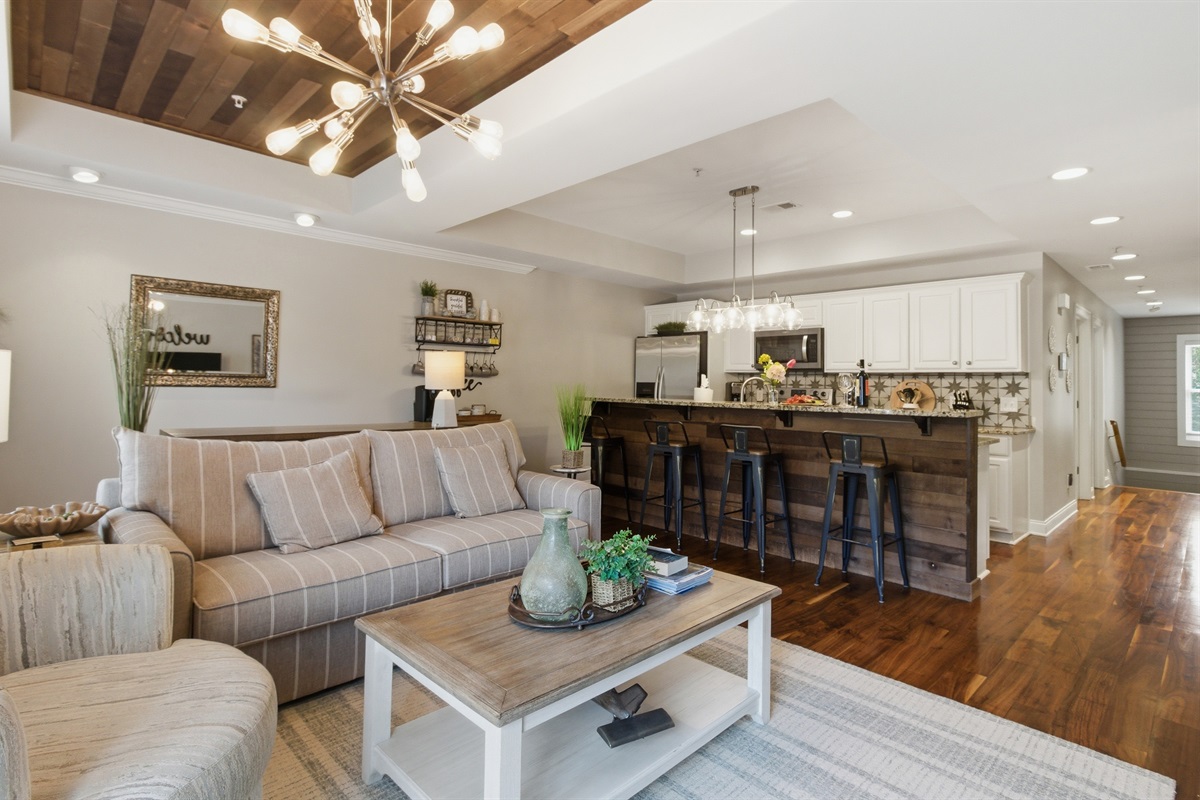 Spacious living area connected to a modern kitchen, perfect for gathering and relaxing.