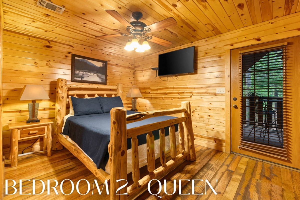Bedroom 2 with queen log bed and warm wood style.