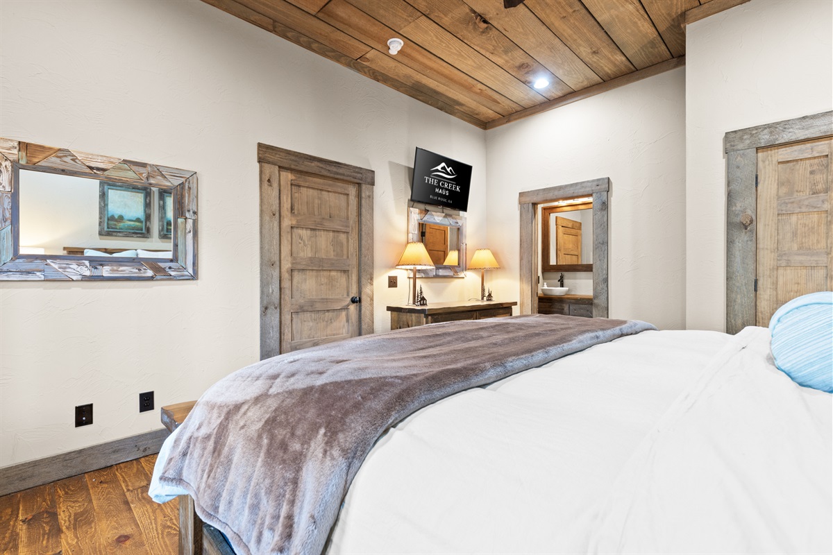 This bedroom oasis featuring a television for unwinding with your favorite show.