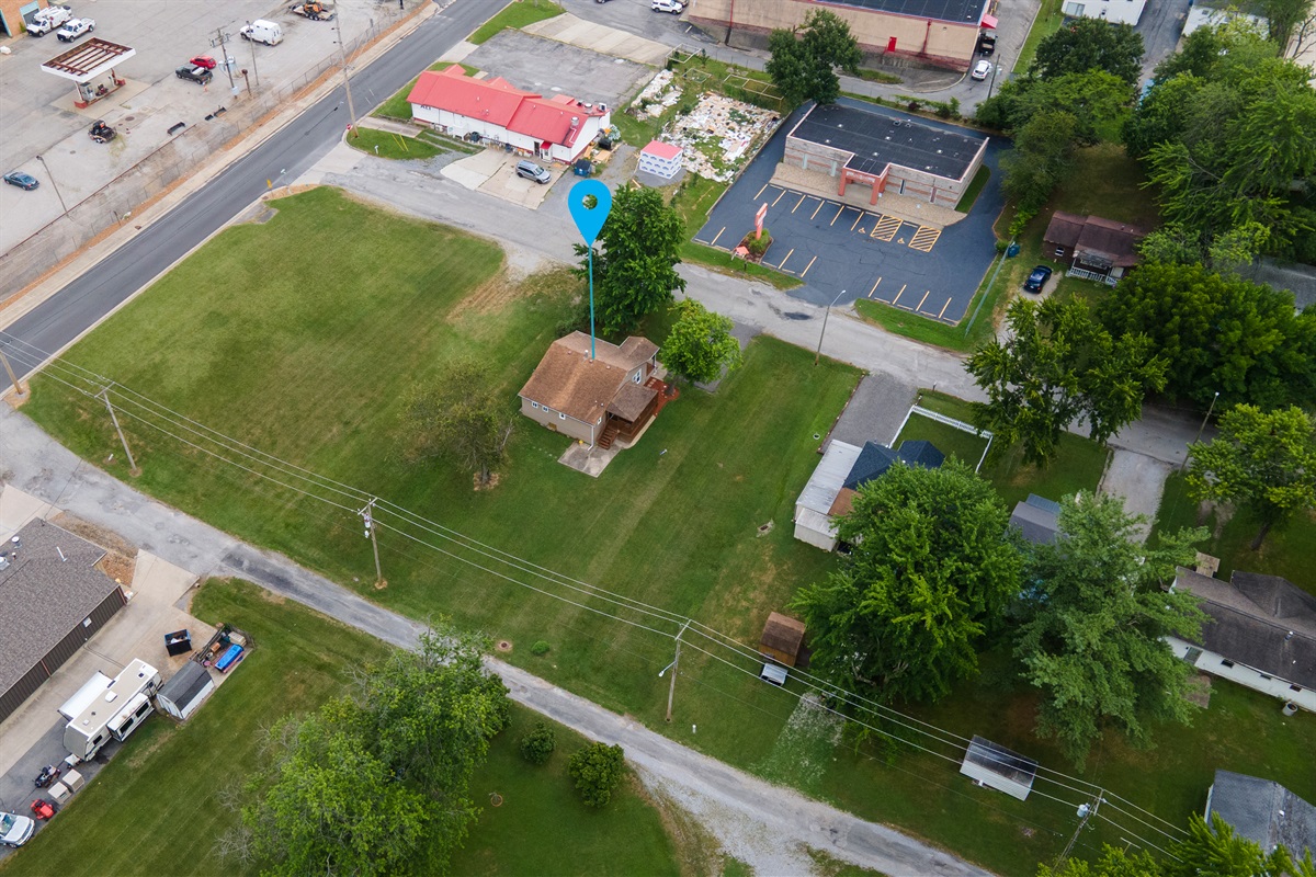 Room to relax, close to everything. Aerial views show a comfortable distance from neighbors, with the heart of town just minutes away.
