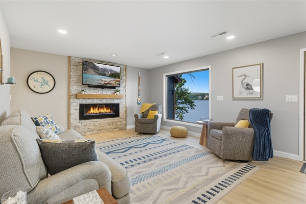 Living room with lake views and electric fireplace