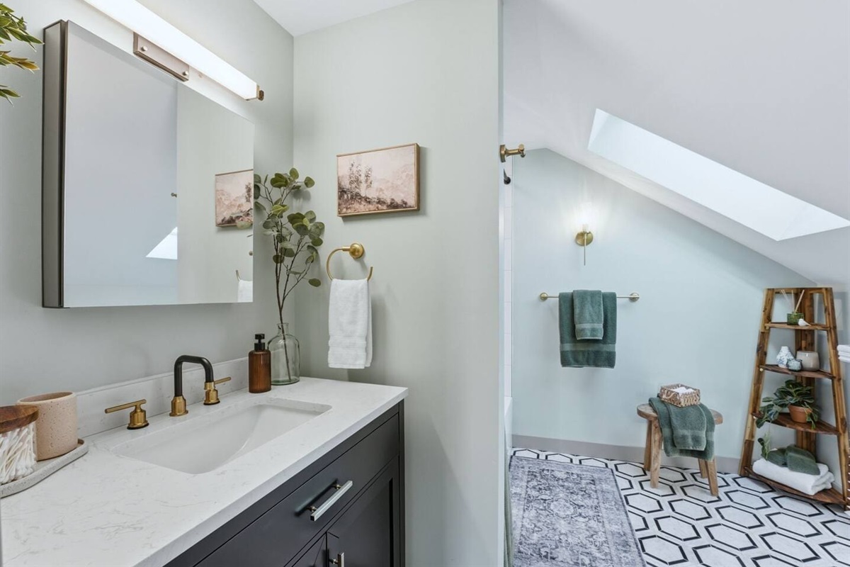 Modern bathroom with a sleek vanity and walk-in shower, thoughtfully styled with warm accents and a clean, calming design
