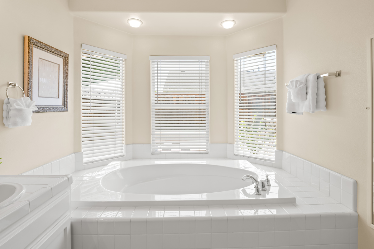 Unwind after a day of adventure in this oversized soaking tub, perfectly positioned beneath bright windows that fill the space with natural light. A peaceful spot to relax and recharge during your stay.