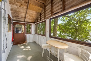 Screened Porch and Indoor living with 2 chairs and one table