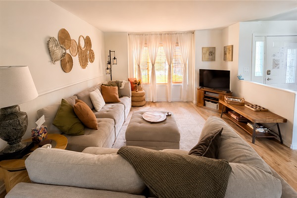 Bright and cozy main living room with oversized sectional seating ~ perfect for movie nights, conversation, and relaxing after a day exploring North Idaho