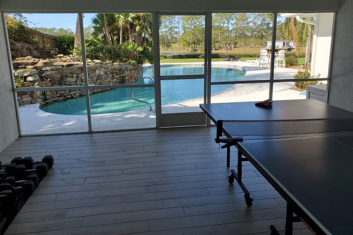 Fitness room with free weights and ping pong table.  