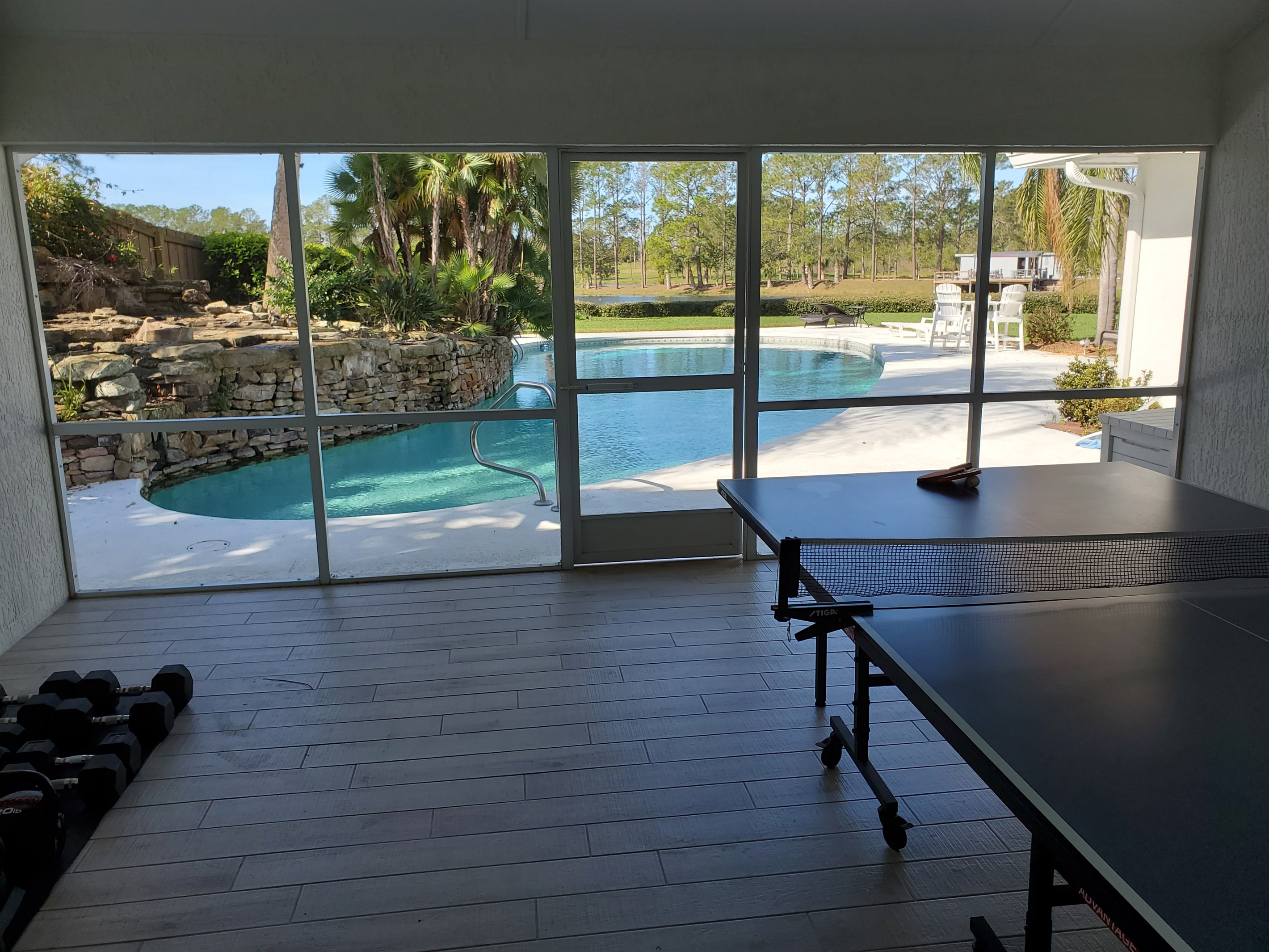 Fitness room with free weights and ping pong table.  