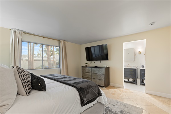 Bedroom with wall-mounted TV and easy access to the ensuite bathroom
