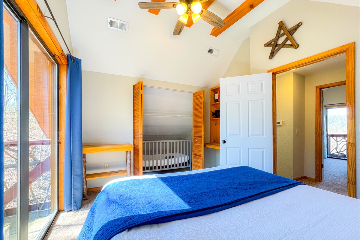 The upper level loft bedroom features a crib just inside the closet.