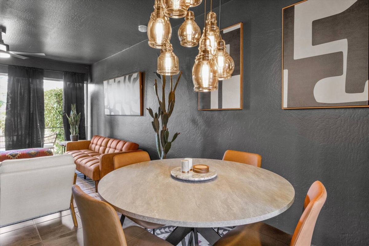 Dining nook with a round table, warm lighting, and a cozy spot to eat or hang out.