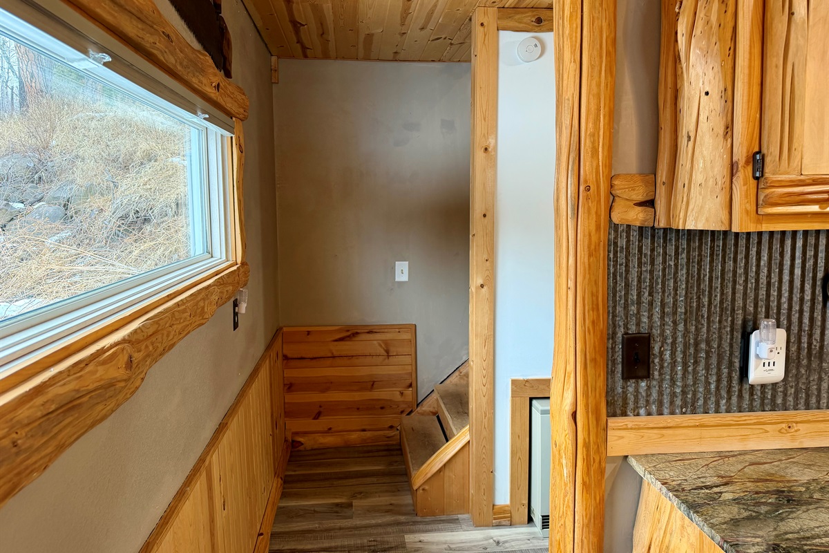Leaving the kitchen, the bathroom is on the right and the stairs are straight ahead to two additional bedrooms. Simple, family-friendly layout with everything close, easy, and convenient.