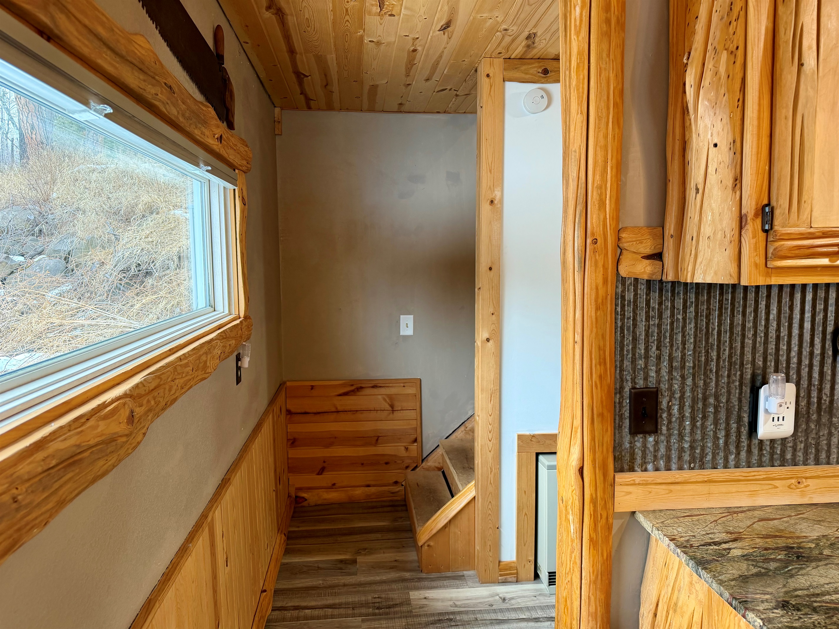 Leaving the kitchen, the bathroom is on the right and the stairs are straight ahead to two additional bedrooms. Simple, family-friendly layout with everything close, easy, and convenient.