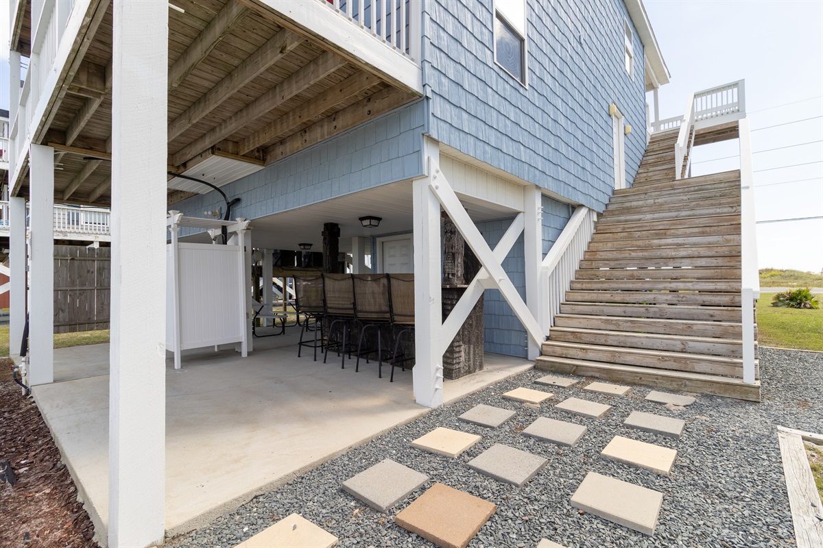Carport and stairs to the first level and entry door