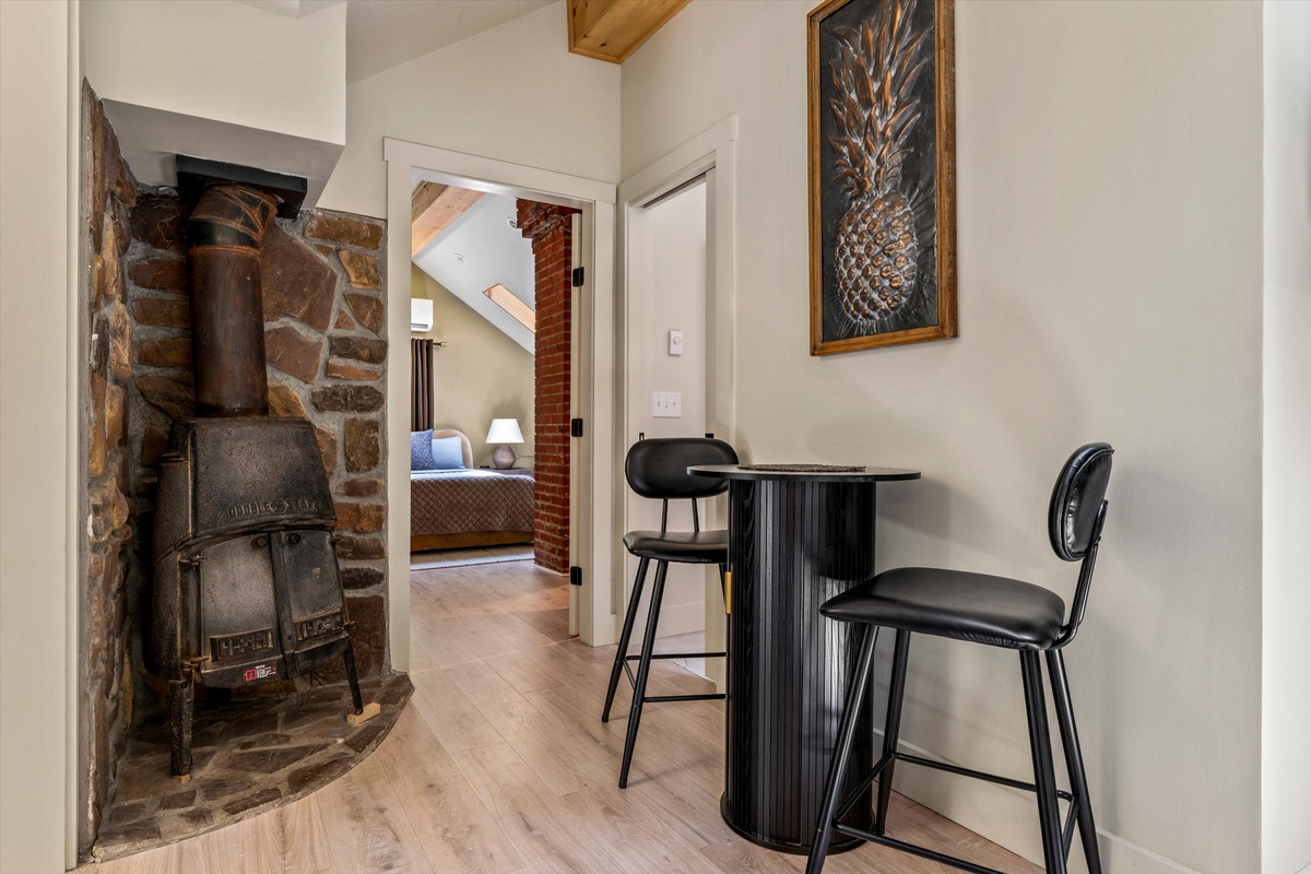 Eating Area with Bistro Table and exposed clay brick fireplace (not operational).