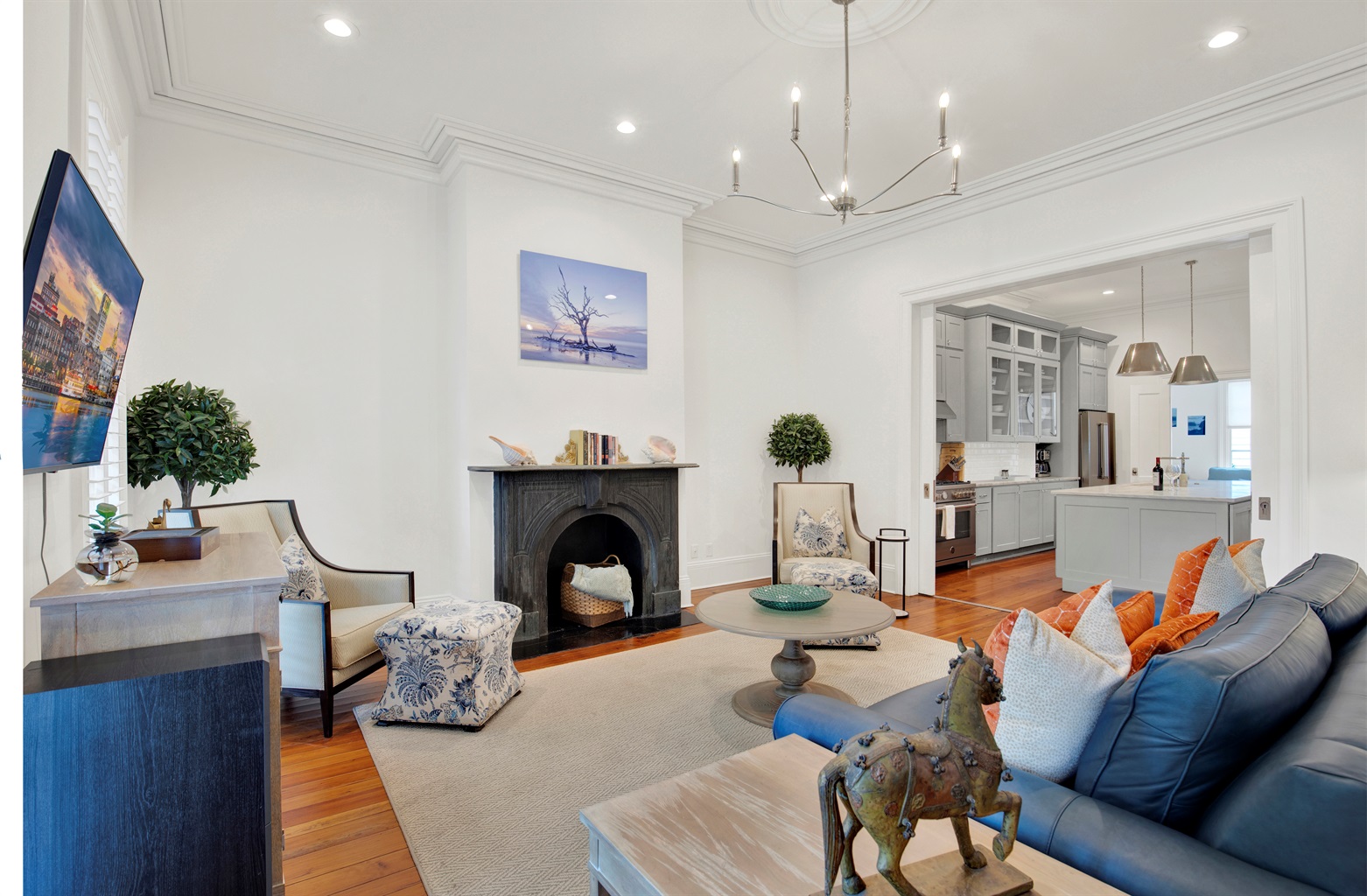 Gracious parlor with floor-to-ceiling windows + heart pine floors.