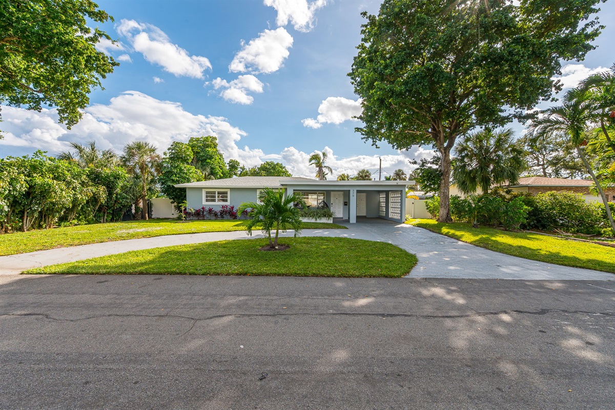 Welcome to your private Pompano Beach retreat—lush landscaping, a spacious circular driveway, and bright coastal charm from the moment you arrive.