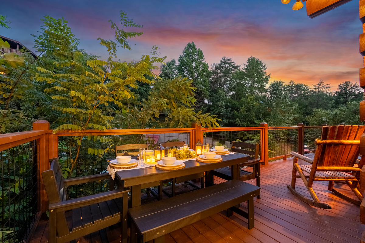 Take in views of the community pool from the spacious deck, complete with outdoor dining for six and two rustic rocking chairs