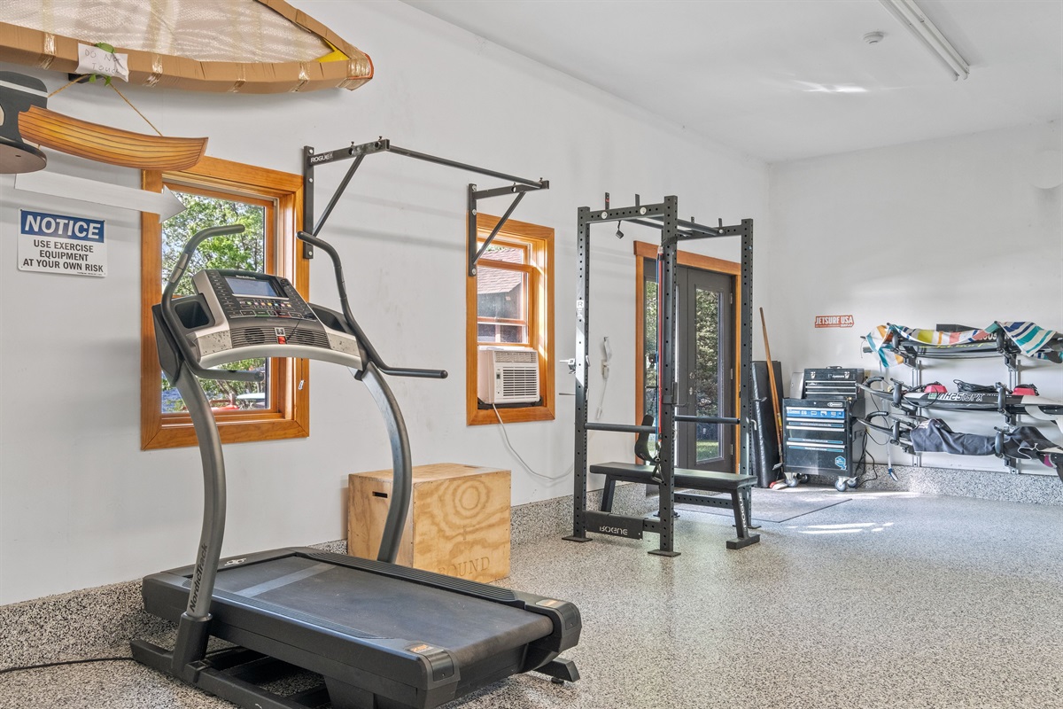 Garage with ping pong, parking for 3 cars, ev chargers, treadmill, and weights, also has a black light system and a bluetooth speaker
