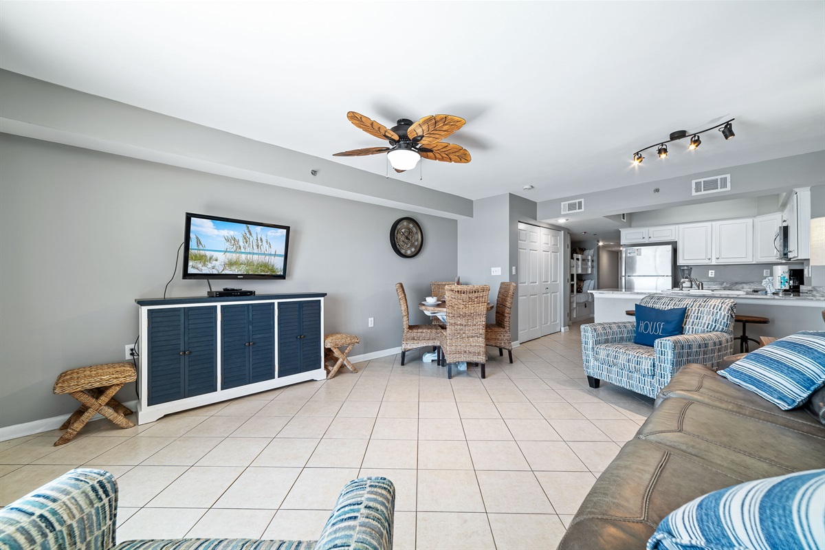 This well-appointed living space offers a comfortable sleeper sofa, flat-screen TV, and a dining area with seating for four, creating a welcoming atmosphere.